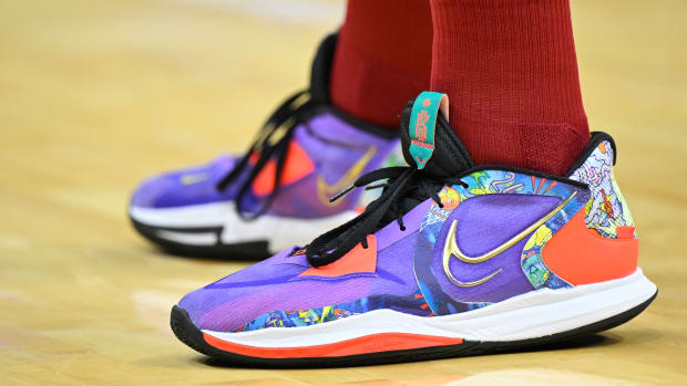 View of purple, black, and white Nike Kyrie shoes.